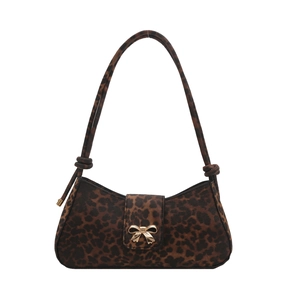 Minimalist leopard print tote bag with gold bow clasp and decorative knot shoulder strap