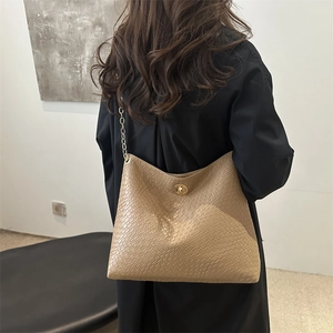 Beige quilted woven shoulder bag with gold chain strap and metallic clasp for women