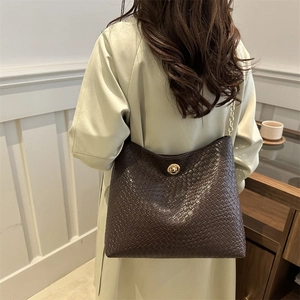 Fashionable dark brown woven crossbody bag with gold chain strap and rotary lock