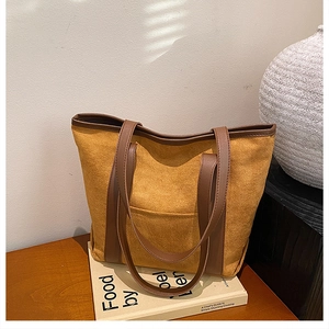 Detail of vintage large tote bag showing ginger suede texture and brown leather straps