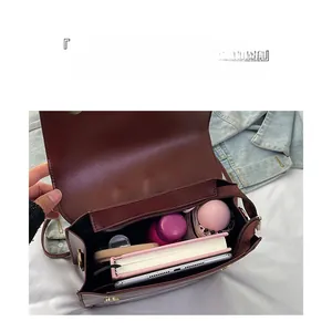 Detailed interior of large capacity mahogany faux leather tote showing spacious compartments
