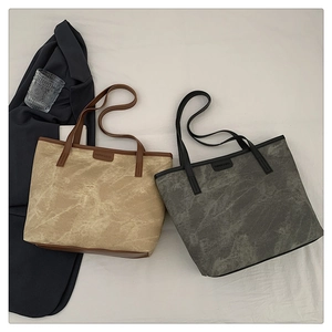 Close-up of dual-color minimalist tote bags with marble texture and fashion logo