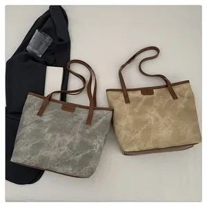 Flat lay of marble texture tote bag with brown leather straps and fashion label