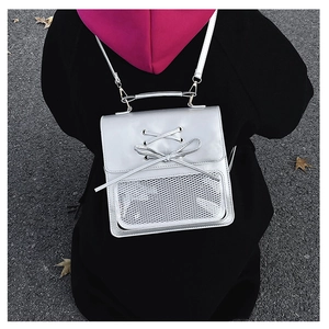 Detail of silver metallic bow backpack with white mesh pocket and thin shoulder straps