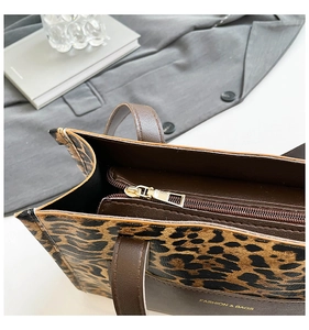 Macro view of leopard print tote bag with metal zipper and fine stitching details