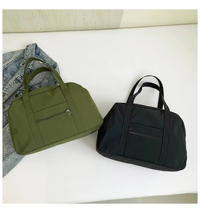 Detail view of large capacity nylon tote bags in olive green and black for travel