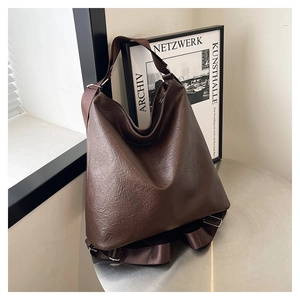 Macro detail of dark brown retro tote bag with textured faux leather and adjustable strap