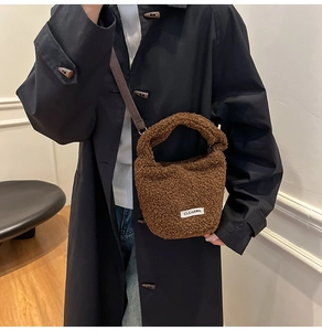 Detail of dark brown faux lamb wool bucket bag with adjustable shoulder strap