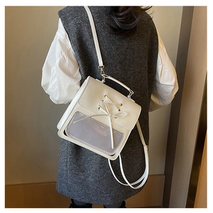 Detailed view of white student backpack with ribbon bow and transparent display window