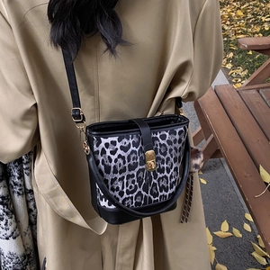 Vintage leopard print bucket bag with black leather trim and gold metal swivel lock