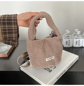 Detail view of khaki faux lamb wool plush bucket bag showing soft texture and strap