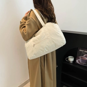 Large beige nylon tote bag for women showing a spacious design and casual aesthetic