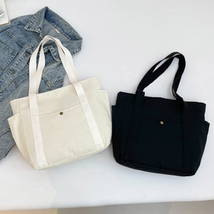 Large capacity canvas tote bags in white and black with side pockets for daily commute