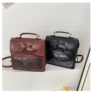 Detail of vintage bow ribbons and clear window on brown and black messenger bags