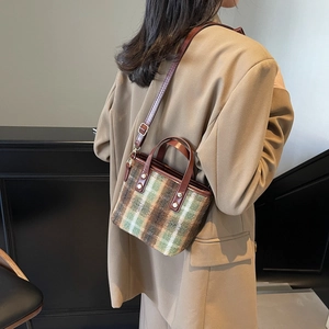 Retro green wool plaid bucket bag with leather handles and gold rivet accents