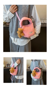 Pink teddy fleece bucket bag detail with plush bear charm and fabric shoulder strap