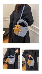 Detail of light blue teddy fleece bucket bag featuring a detachable brown plush bear charm
