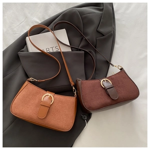 Close-up of retro matte leather bag with golden buckle and sleek shoulder strap