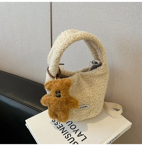 Detailed texture of off-white faux lamb wool bucket bag with a cute brown bear charm