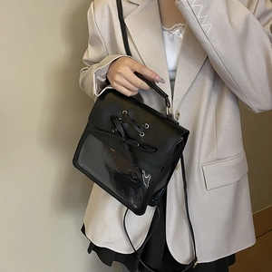 Japanese style black ita bag with bow detail and clear window shown on shoulder