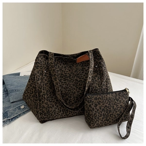 Close-up of leopard print tote bag and matching pouch with detailed canvas texture
