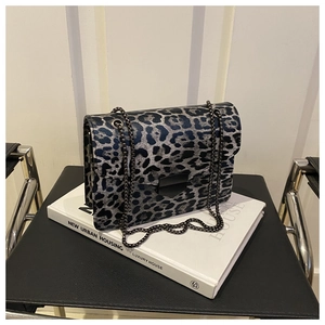 Detailed view of grey leopard print shoulder bag with black metal chain and matte buckle