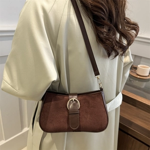 Retro dark brown matte suede underarm bag with vintage buckle on white trench coat
