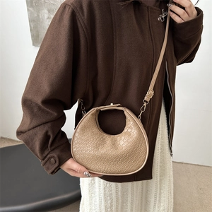 Beige crescent handbag with crocodile texture and metal clasp for women