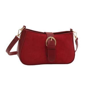 Minimalist red leather and suede shoulder bag with gold hardware on white background