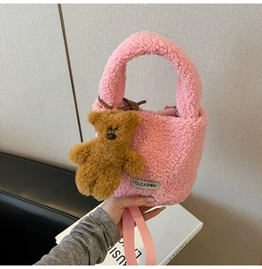 Detailed view of pink fuzzy lamb wool bucket bag with cute brown bear charm