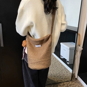 Brown fuzzy fleece bucket bag with Love Fashion label and cute bear charm pendant