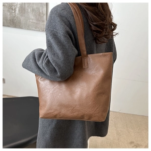 Close-up of the vintage cracked texture leather on this large brown shoulder tote bag