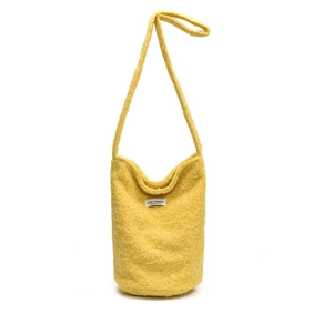Bright yellow wool bucket bag with adjustable strap and soft plush texture