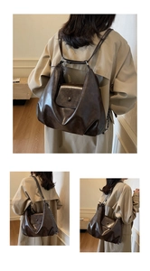 Detail view of a vintage dark brown leather backpack with retro metal chain and button
