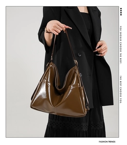 Detail view of deep brown hobo bag with glossy oil-wax finish and side pockets