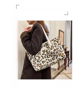 Detailed shoulder view of a leopard print plush tote bag with a small matching coin purse