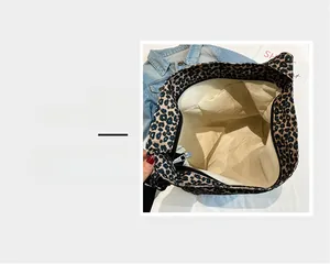 Detail magnification showing leopard print tote interior with durable zipper and lining