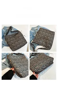 Macro detail of large canvas tote bag featuring classic leopard print and wide shoulder strap