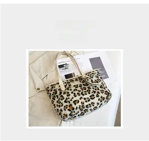 Detailed view of leopard print plush tote bag with matching round coin purse charm
