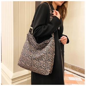 Detail view of large leopard print tote bag with wide strap for shoulder or crossbody wear