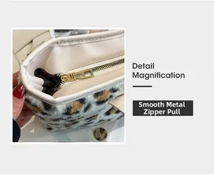 Detail magnification of smooth gold metal zipper on leopard print faux fur tote bag