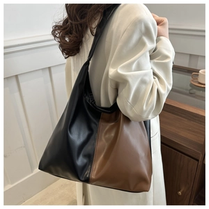 Detailed view of the large capacity black and brown patchwork hobo shoulder tote bag