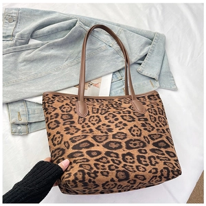 Detail of vintage leopard print tote bag with reinforced stitching and slim brown handles