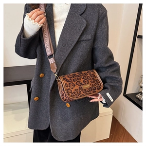 Detail of leopard print crossbody bag with fashion gold plate and wide woven strap
