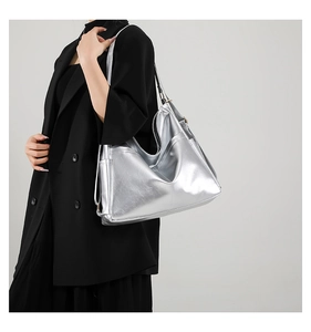 Close-up of a high-capacity silver metallic tote bag with textured faux leather finish