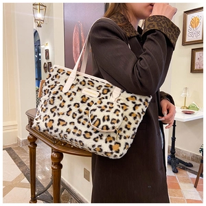 Detail of leopard print faux fur tote bag with matching mini pouch and leather logo patch