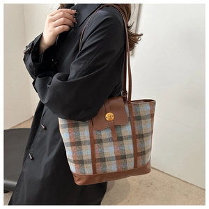 Detailed view of the vintage plaid wool tote bag showing texture and leather trim