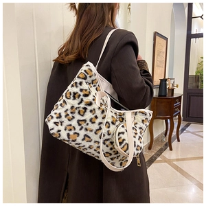 Faux fur leopard print tote bag with a mini round pouch shown on a model shoulder
