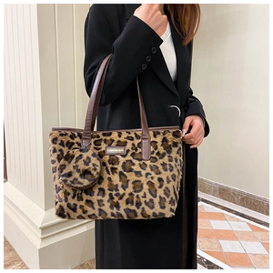 Detail view of leopard print faux fur tote bag with brown leather handles and coin purse