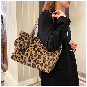 Detail view of leopard print plush tote bag with a matching round coin purse on handle